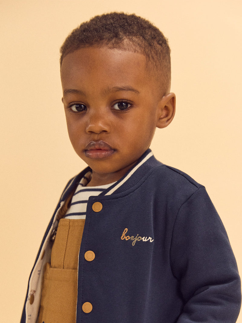 Reversibler Teddy in Marineblau oder Elfenbein mit Hundemuster für Baby Jungen